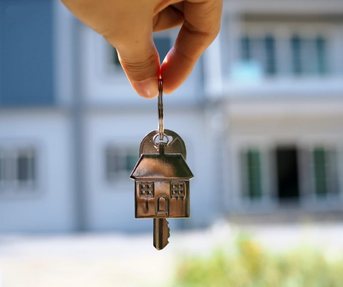 person holding a key from a new home