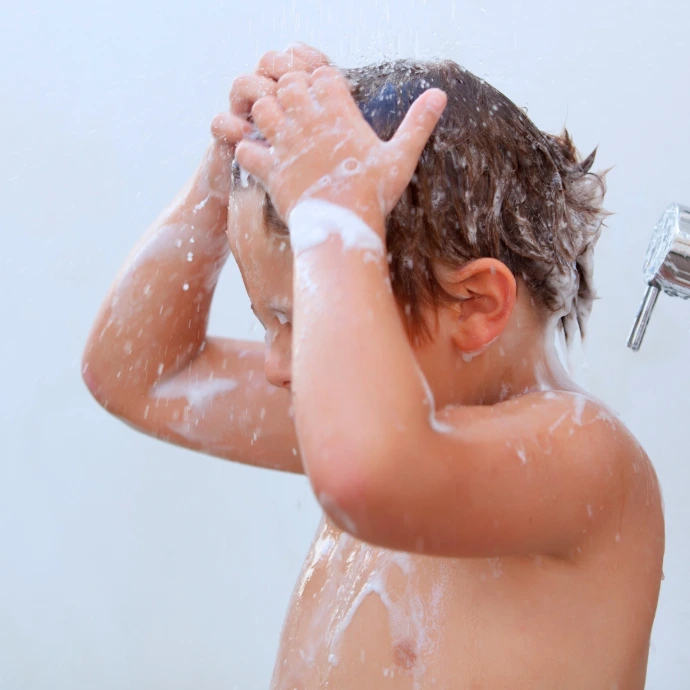 Baby taking shower with shower filter